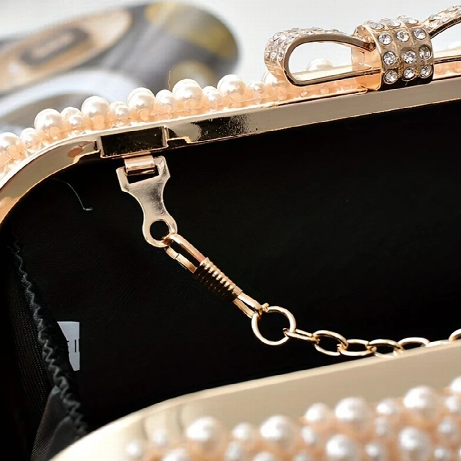 Close-up of the pearl trim, crystal clasp and lining on a NANJER evening bag